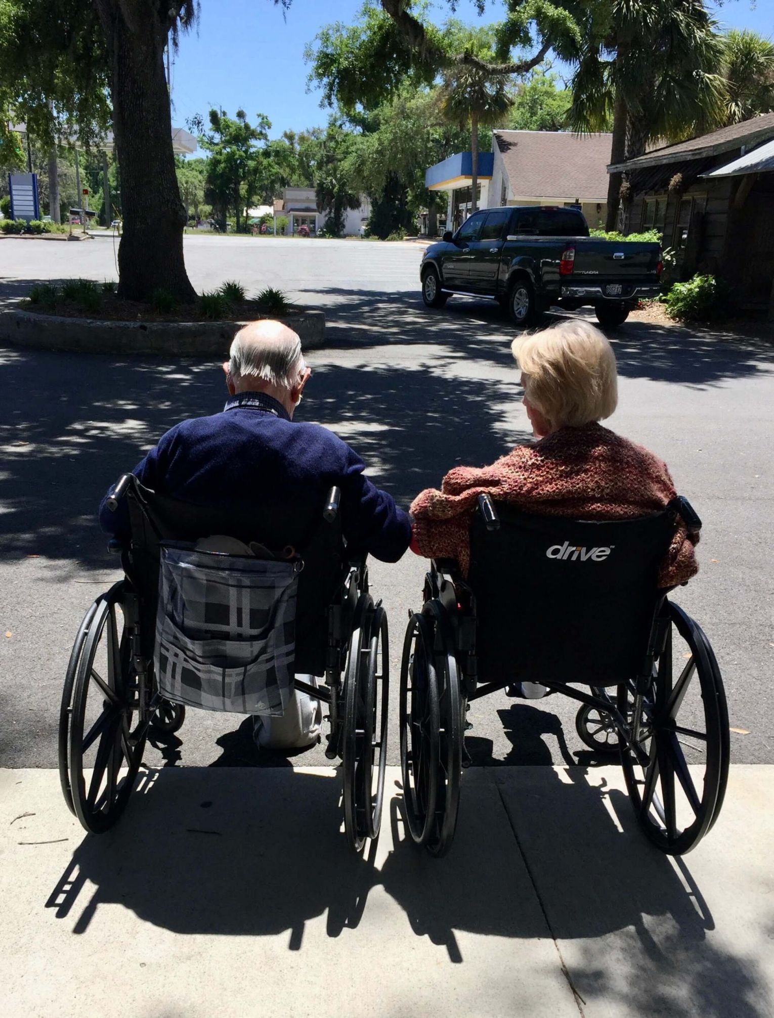 Seniors in wheelchairs at assisted living facility 