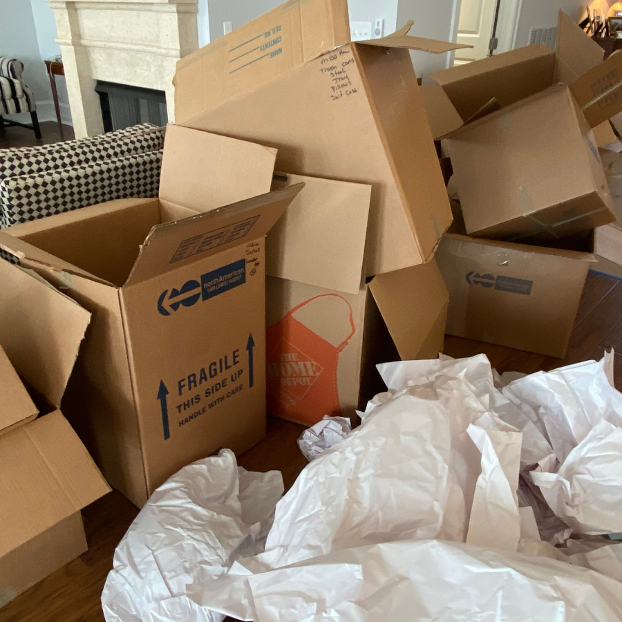 packing moving boxes in living room